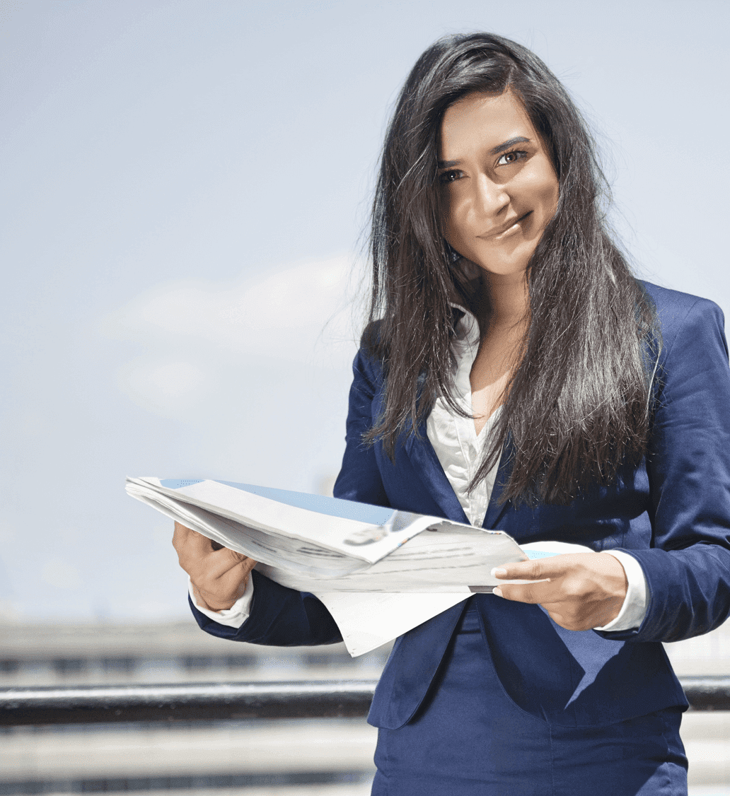 A professional woman in a business suit holding the Hindustan times newspaper, staying informed and up-to-date.