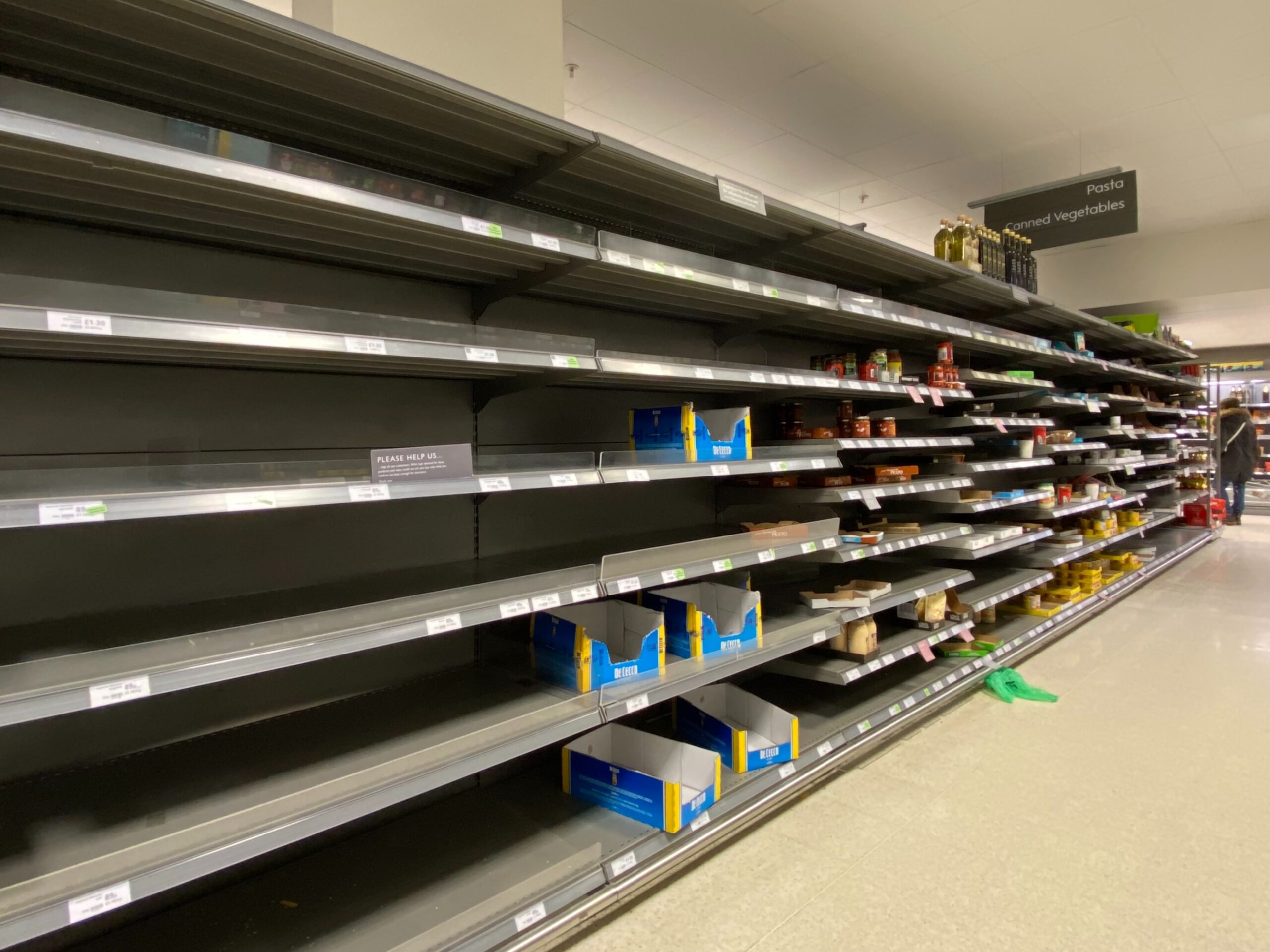 Long rows of empty shelves at a department store.